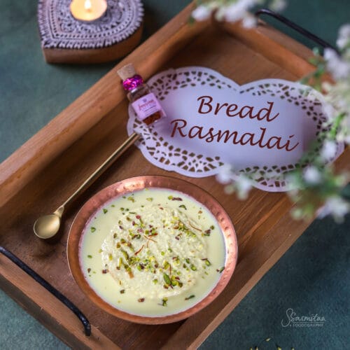 Bread Rasmalai made with soft bread soaked in creamy saffron milk and topped with pistachios