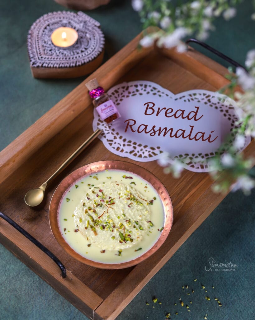 Bread Rasmalai made with soft bread soaked in creamy saffron milk and topped with pistachios